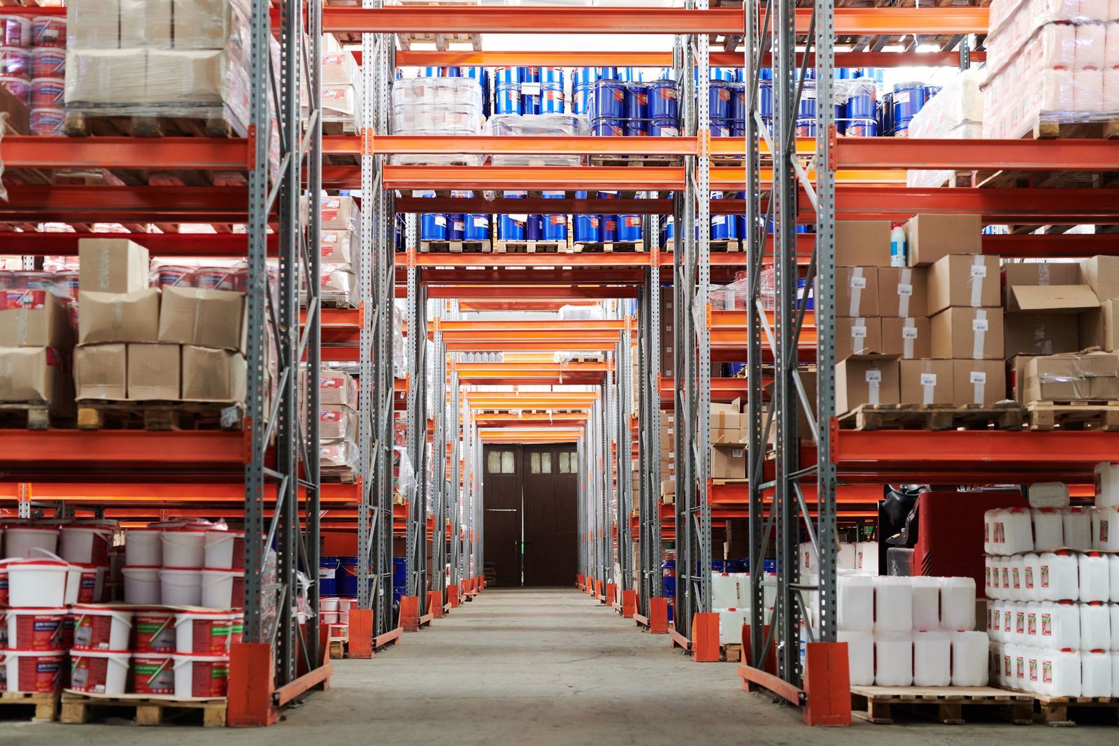Warehouse aisle with tall pallet racking stocked with packaged goods
